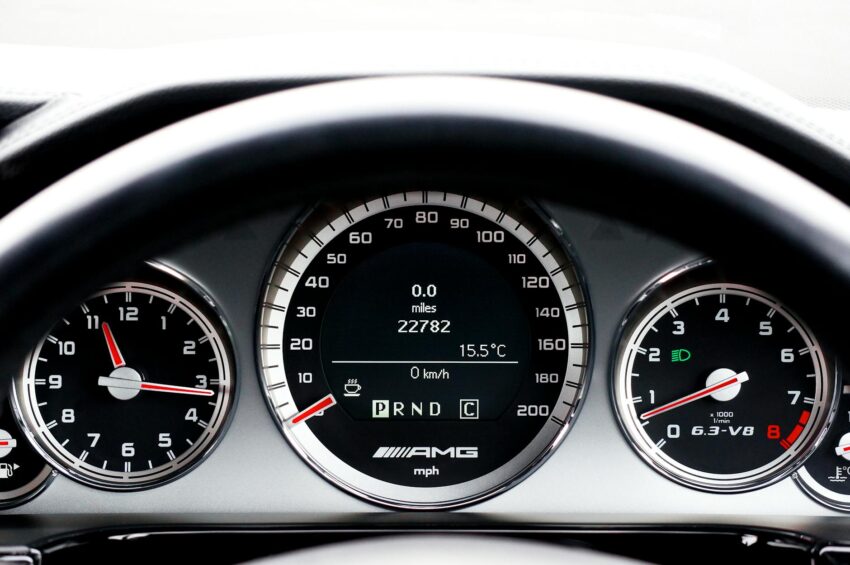 Detailed close-up of a vehicle dashboard featuring modern speedometers and controls.