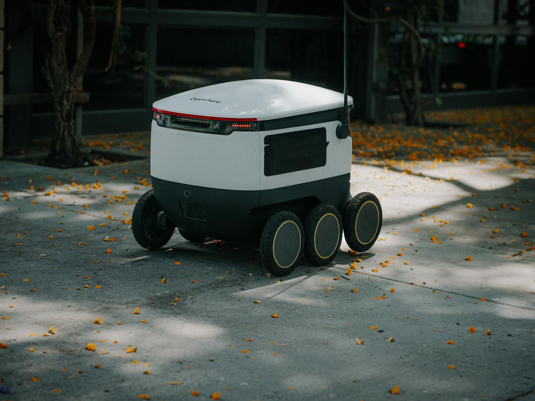 Innovative delivery robot navigating city streets autonomously.