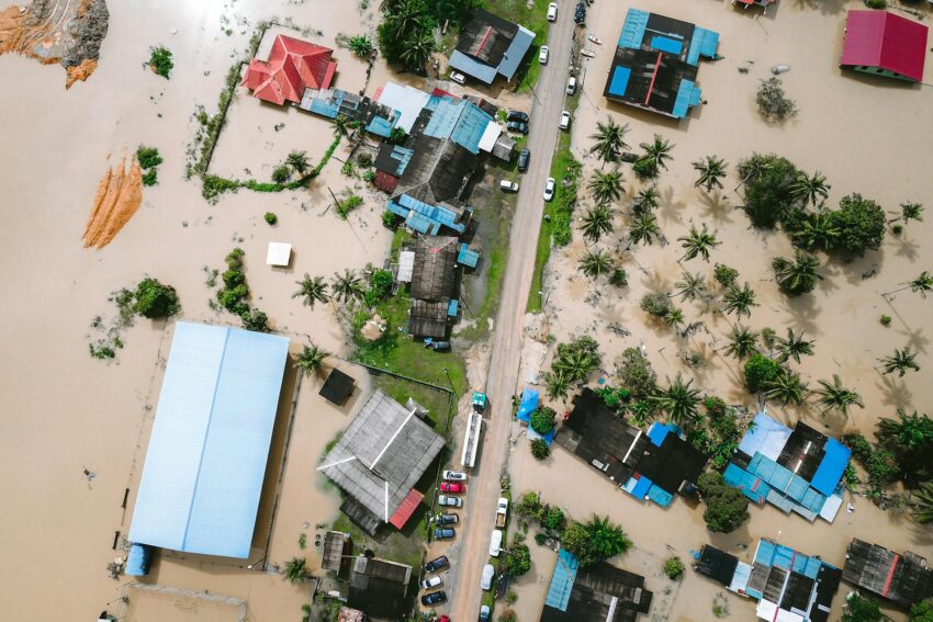 Drone view of a residential area in Kijal, Malaysia, showing extensive flooding and submerged buildings.