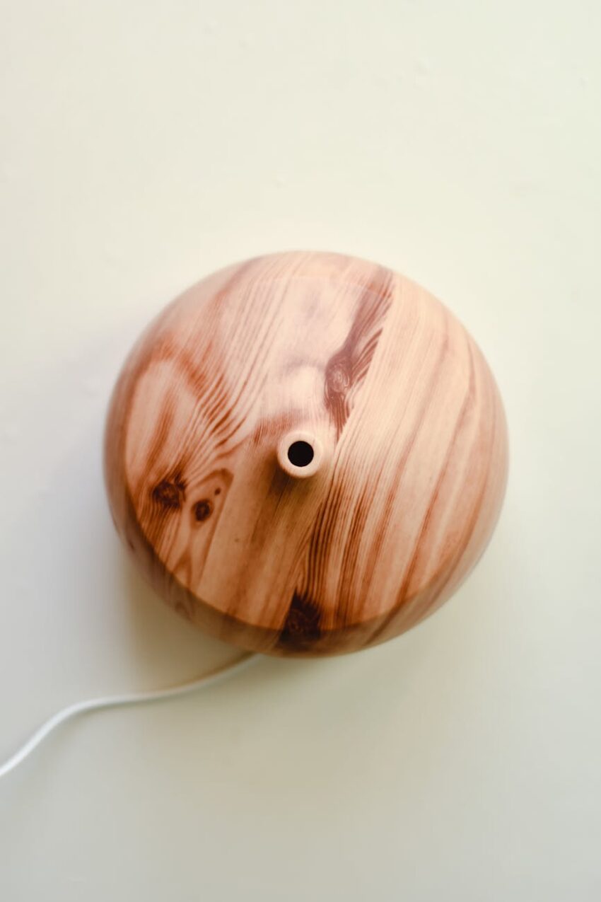 Wooden aromatherapy diffuser on a white surface, offering calming scents and relaxation.