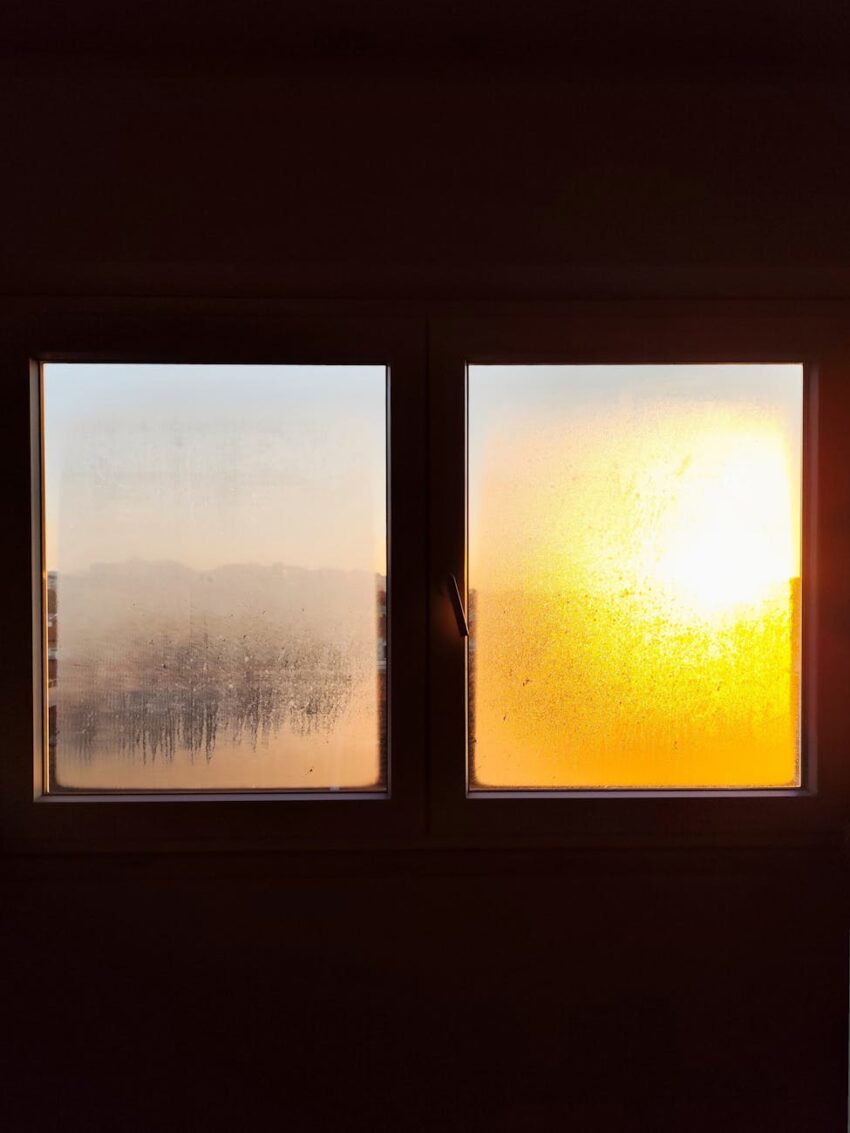 Sunrise casting warm light through a frosted window, creating a serene atmosphere.