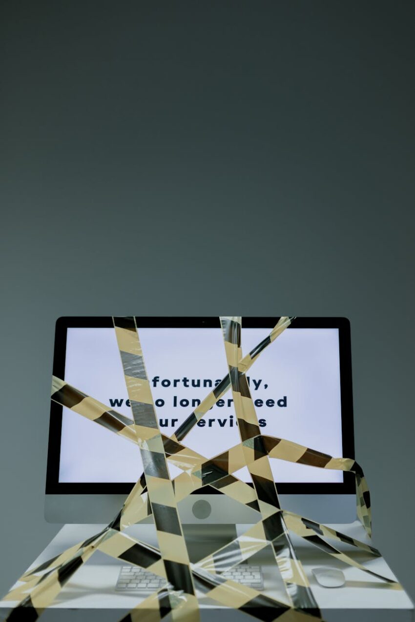 Computer screen displaying a termination message with security tape, symbolizing job loss.