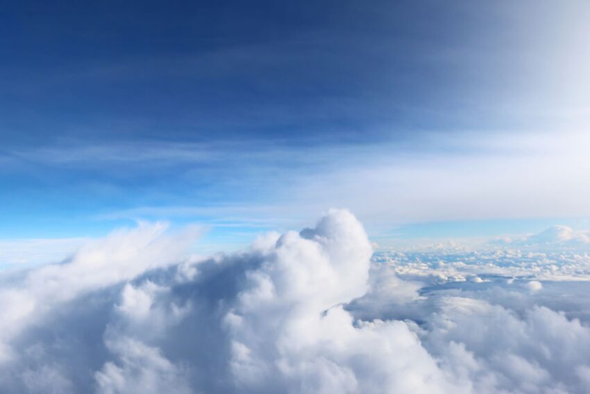 A tranquil aerial view of fluffy white clouds against a blue sky over Berlin, Germany.